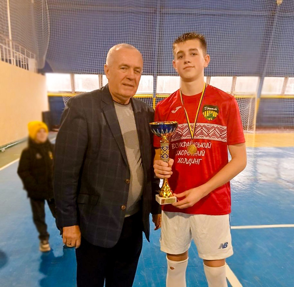 Олександр Панюта вручає кубок капітану команди Кагарлицького ліцею №1 імені Василя Мамія - переможцю турніру